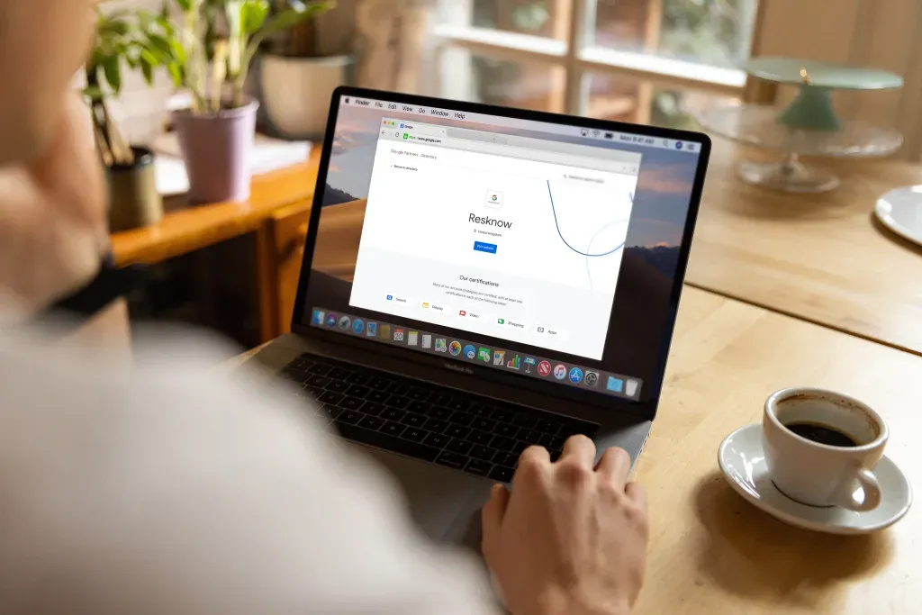 Man looking at a laptop screen showing Resknow's Google Partner status